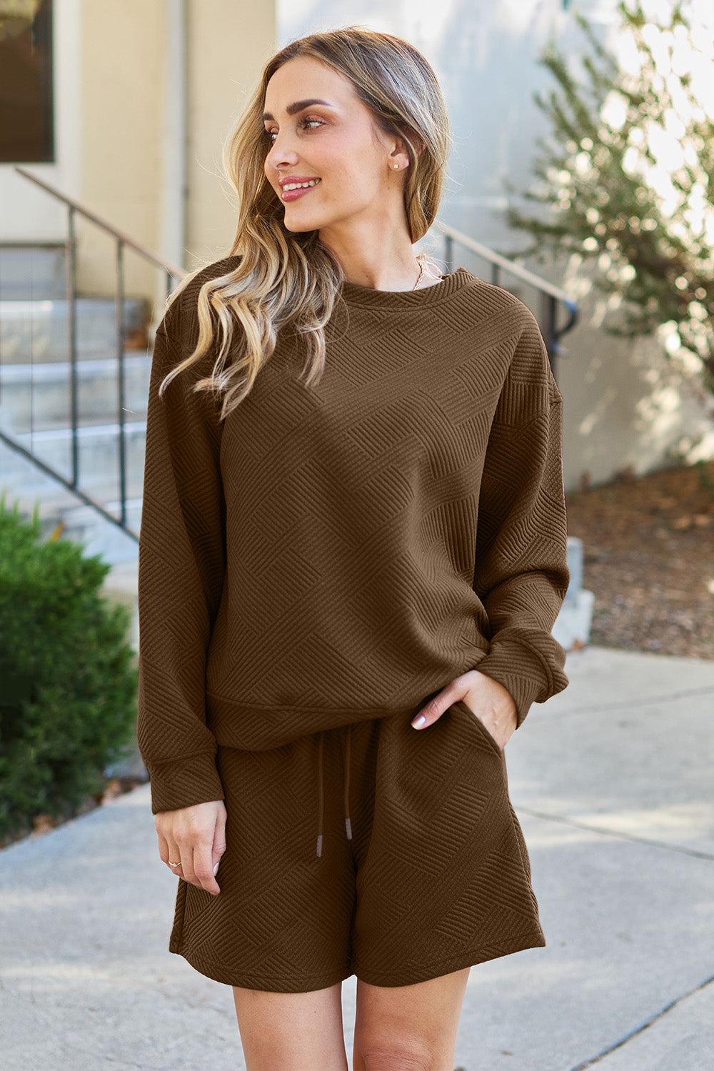 Long-sleeve top with a round neck and cozy dropped shoulders, paired with drawstring shorts.