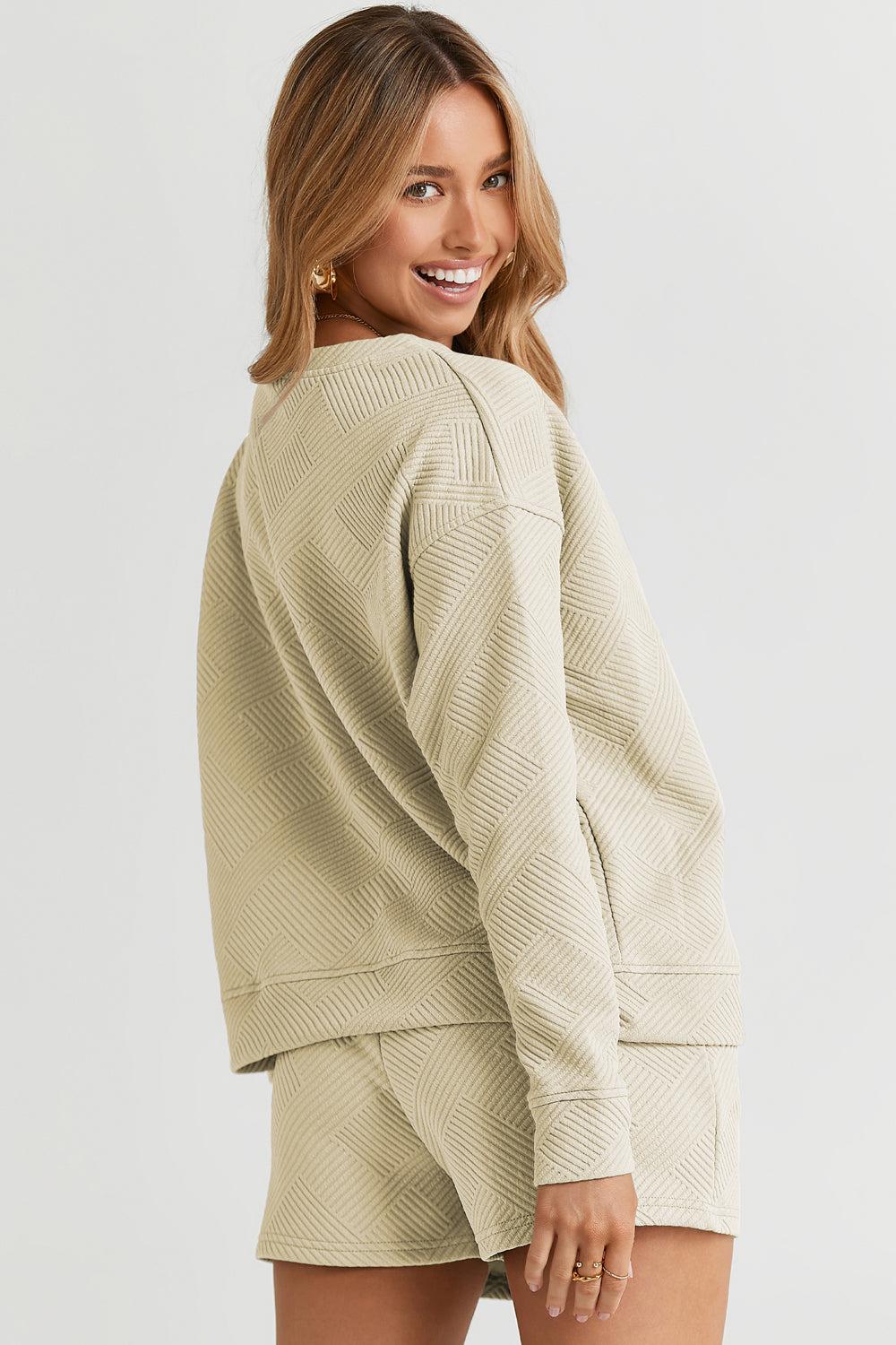 Long-sleeve top with a round neck and cozy dropped shoulders, paired with drawstring shorts.