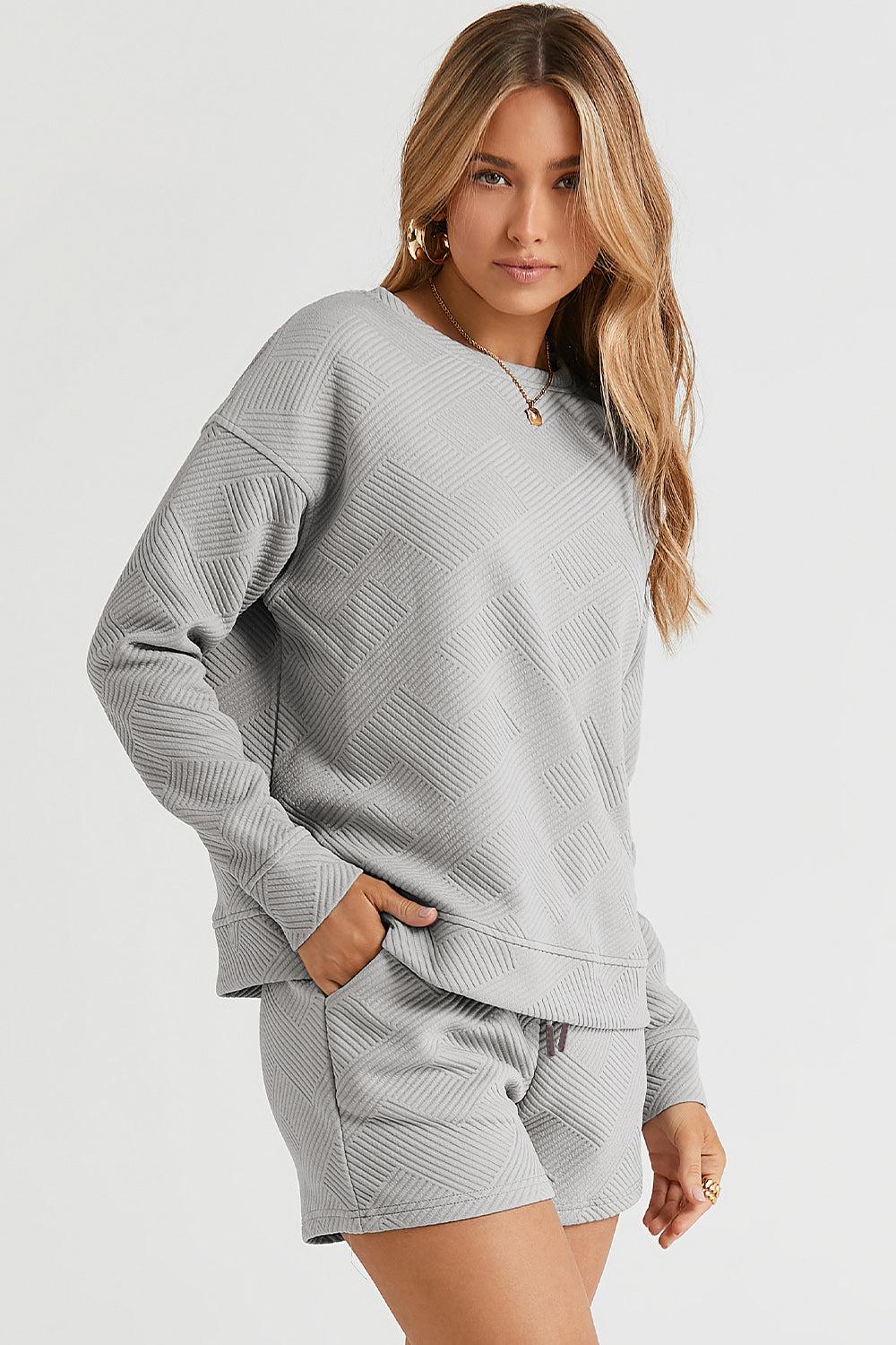 Long-sleeve top with a round neck and cozy dropped shoulders, paired with drawstring shorts.