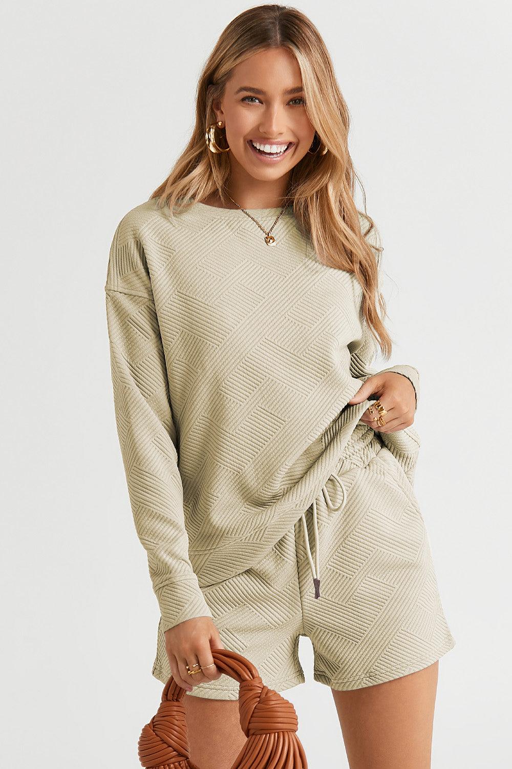 Long-sleeve top with a round neck and cozy dropped shoulders, paired with drawstring shorts.